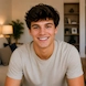 Portrait of Michael Anderson smiling in a modern home interior after sharing his positive experience with Webomaze's SEO, AEO, GEO, and AIO services.